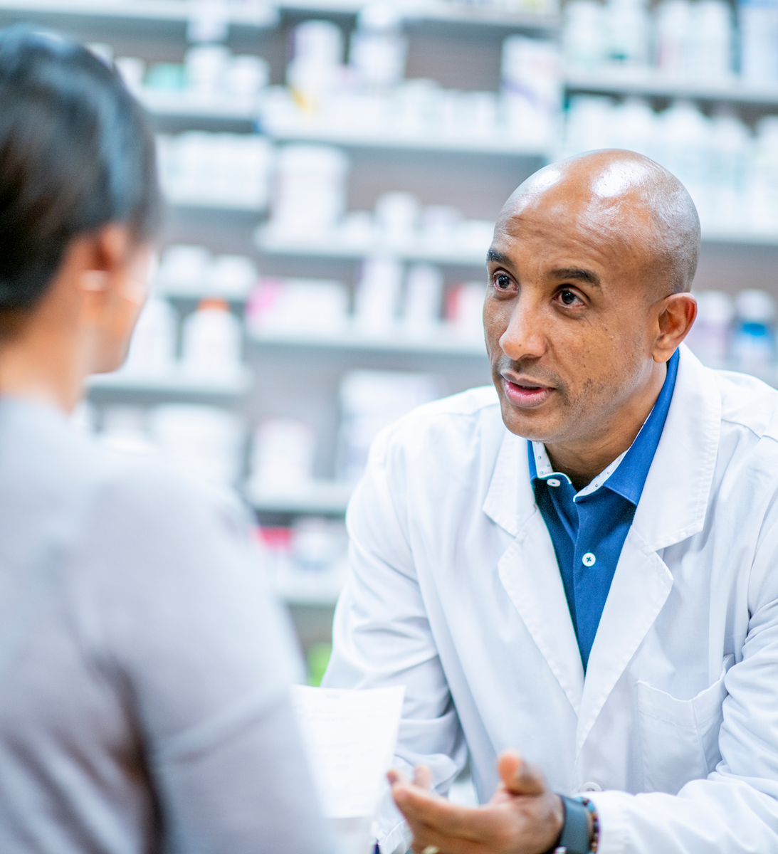 Pharmacist having conversation with customer